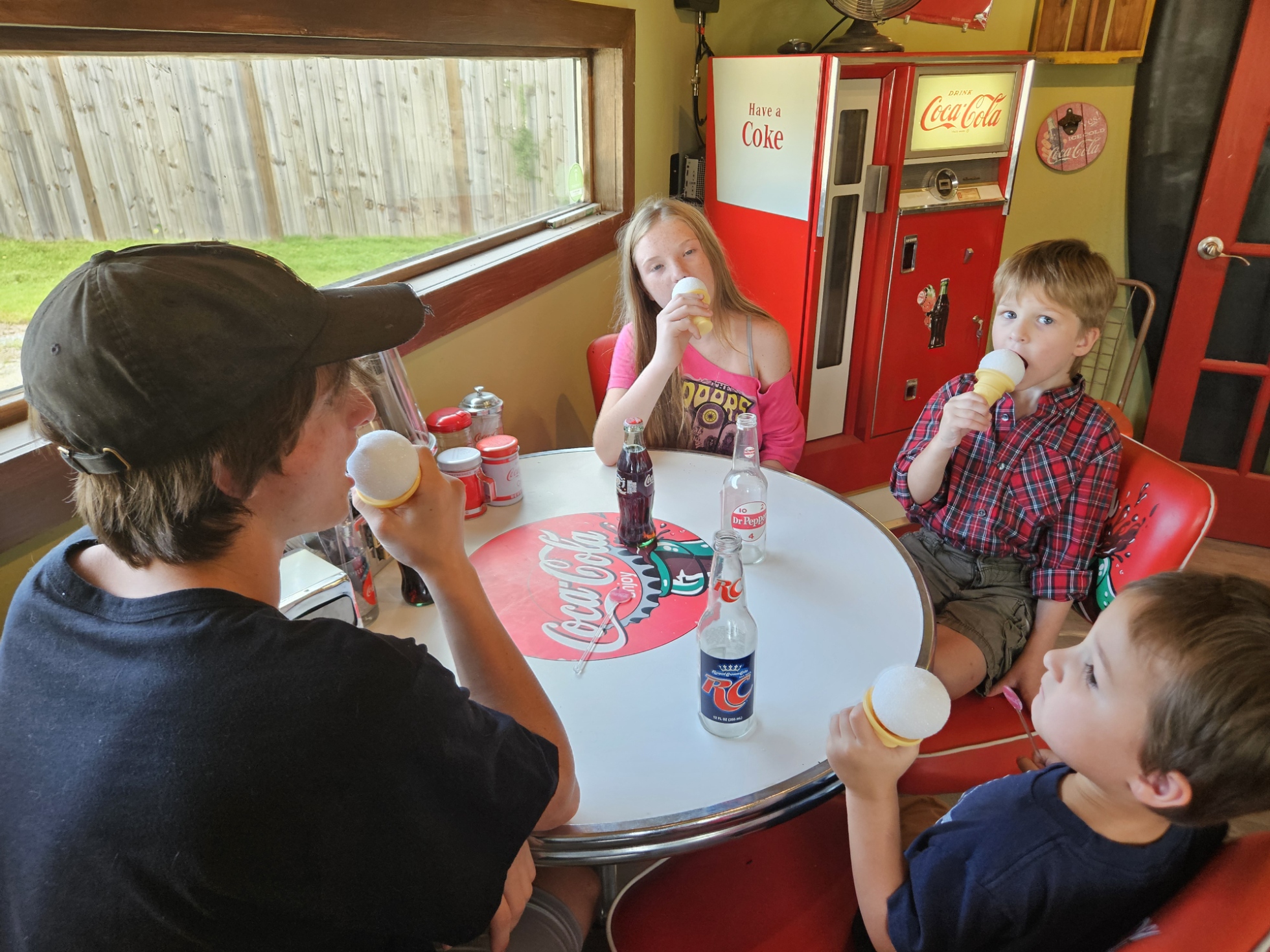 Four kids eating pretend ice cream cones